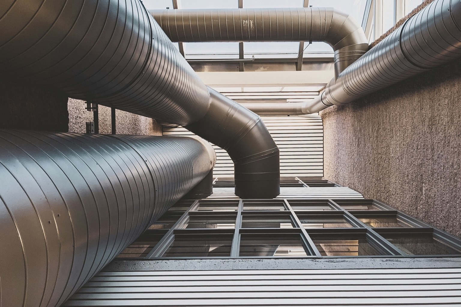 Jacketed and insulated piping runs in bright daylight